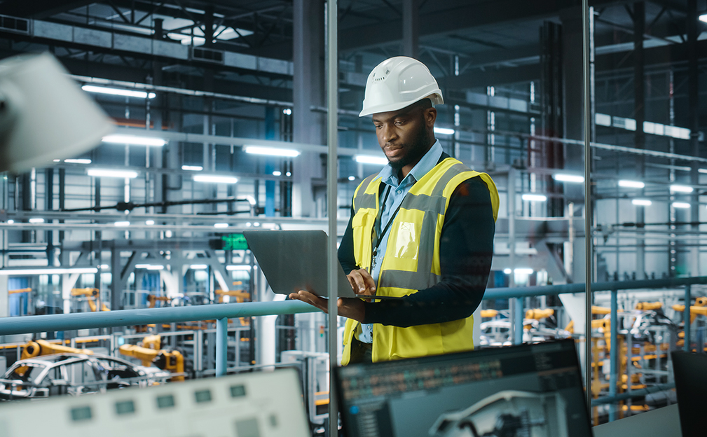 Young man with hard hat working at an indoor  construction job